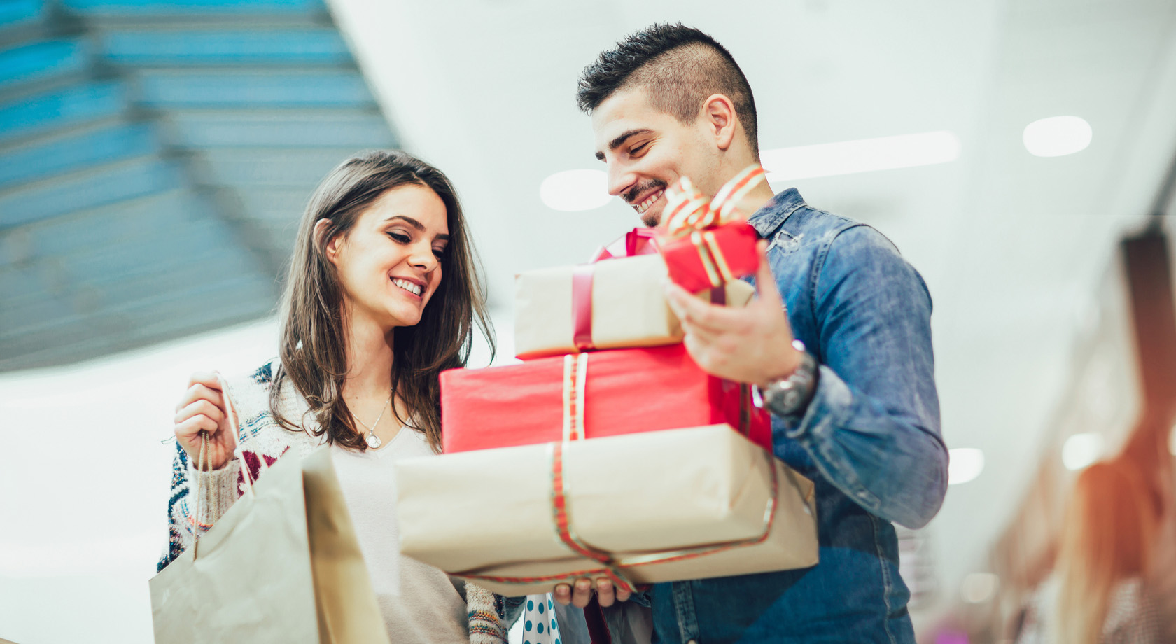 Man and Woman holding presents